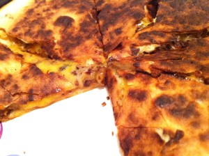 Crispy tortilla + leftover black bean burgers + melty cheese